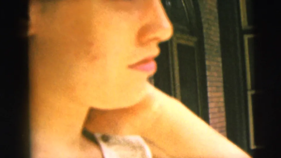 Close side profile of a woman in warm 8mm color, likely from the same 1962 Camden home-movie sequence.