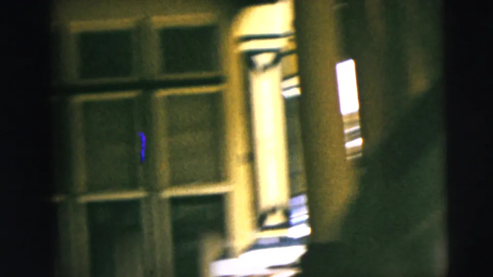 Final 1962 Camden frame with soft motion blur on the porch window, railing and warm light as the camera moves away.