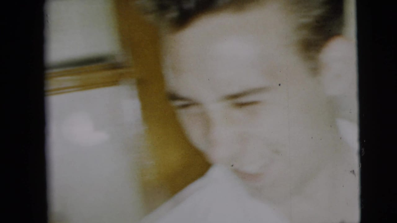 Soft close view of a person looking downward in a bright interior frame.