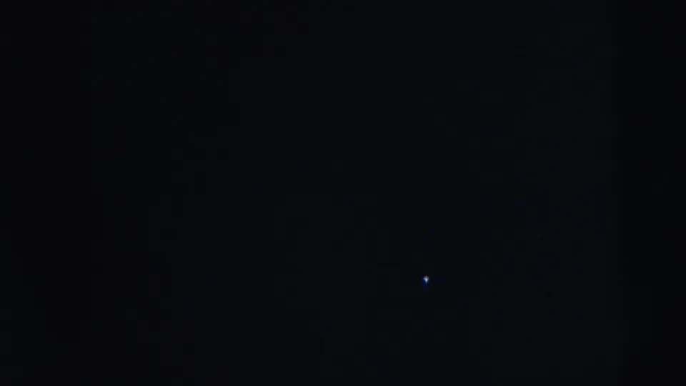 Dark, underexposed 8mm frame from the Camden 1962 clip with no identifiable people or setting visible.