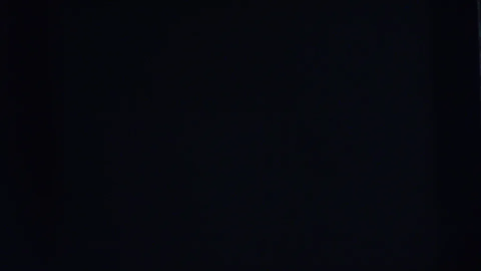 Underexposed 8mm frame in the 1962 Camden sequence, with only faint film texture visible.