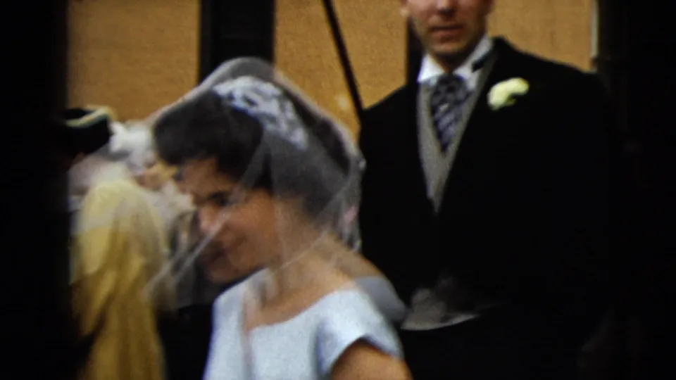 Bride in veil and light gown stands near a groom in a dark suit during a 1962 Camden wedding moment.