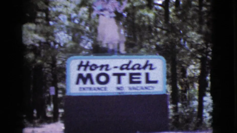 The Hon-dah Motel sign is visible in a wooded roadside setting during the 1964 Cottonwood, Arizona home-movie clip.