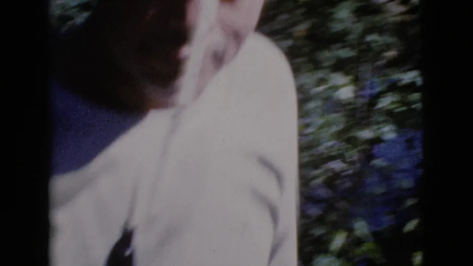 The final 1964 Cottonwood, Arizona frame is a blurred close view of the male figure moving near dense streamside foliage.