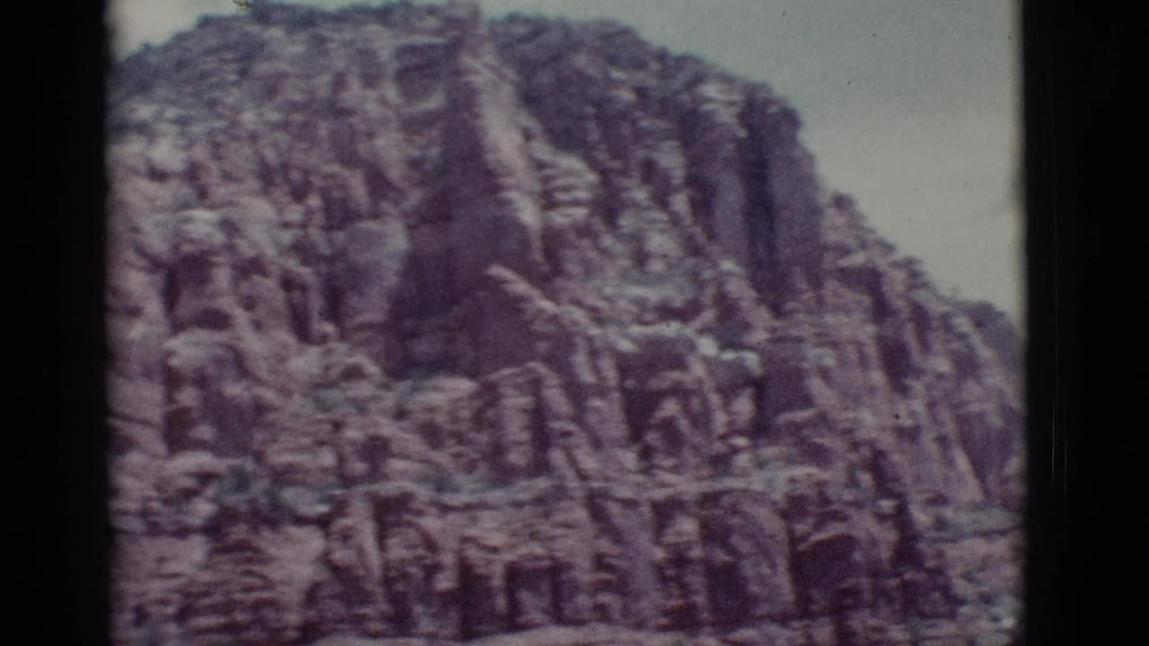 Close view of a rough layered rock wall filling most of the frame.