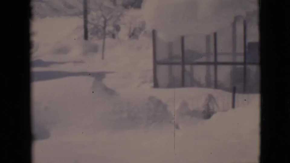 Clarkdale, Arizona 1966 home-movie frame showing a snowy residential yard with fence posts and bare winter trees.