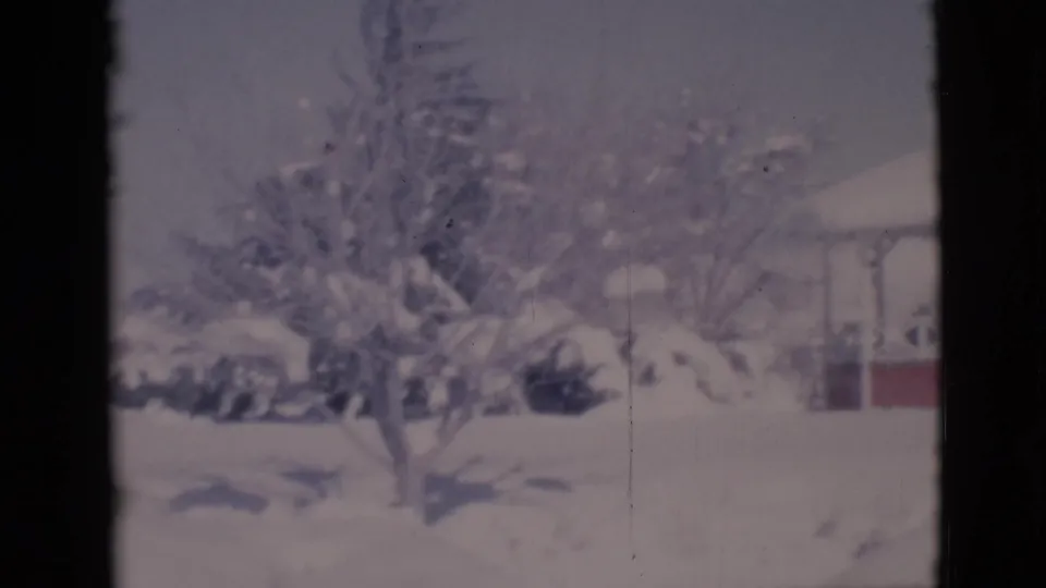 1966 Clarkdale, Arizona 8mm frame showing a snowy yard, bare tree, and partial view of a white gazebo with red trim.