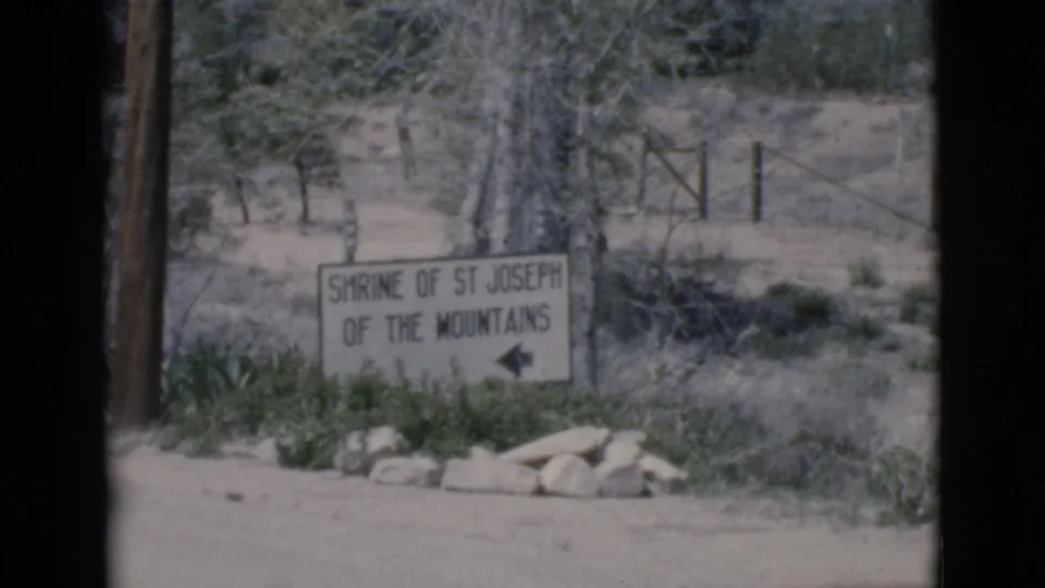 Visitor-shot 8mm view of the Shrine of St Joseph of the Mountains entrance sign in Clarkdale, Arizona.