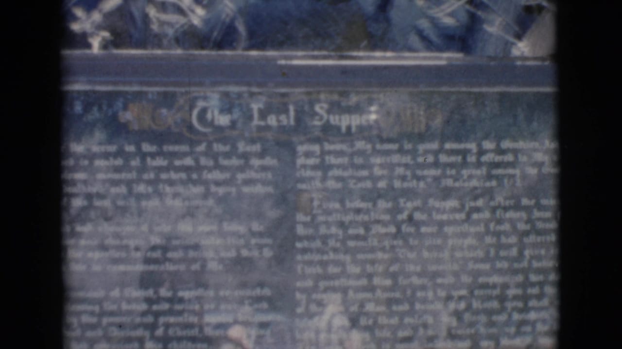 1966 Clarkdale, Arizona 8mm frame showing a soft close-up of a dark Last Supper marker with white lettering.