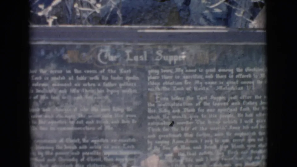 Soft 8mm close-up of the Last Supper marker in Clarkdale, Arizona, with dark backing and pale printed text.
