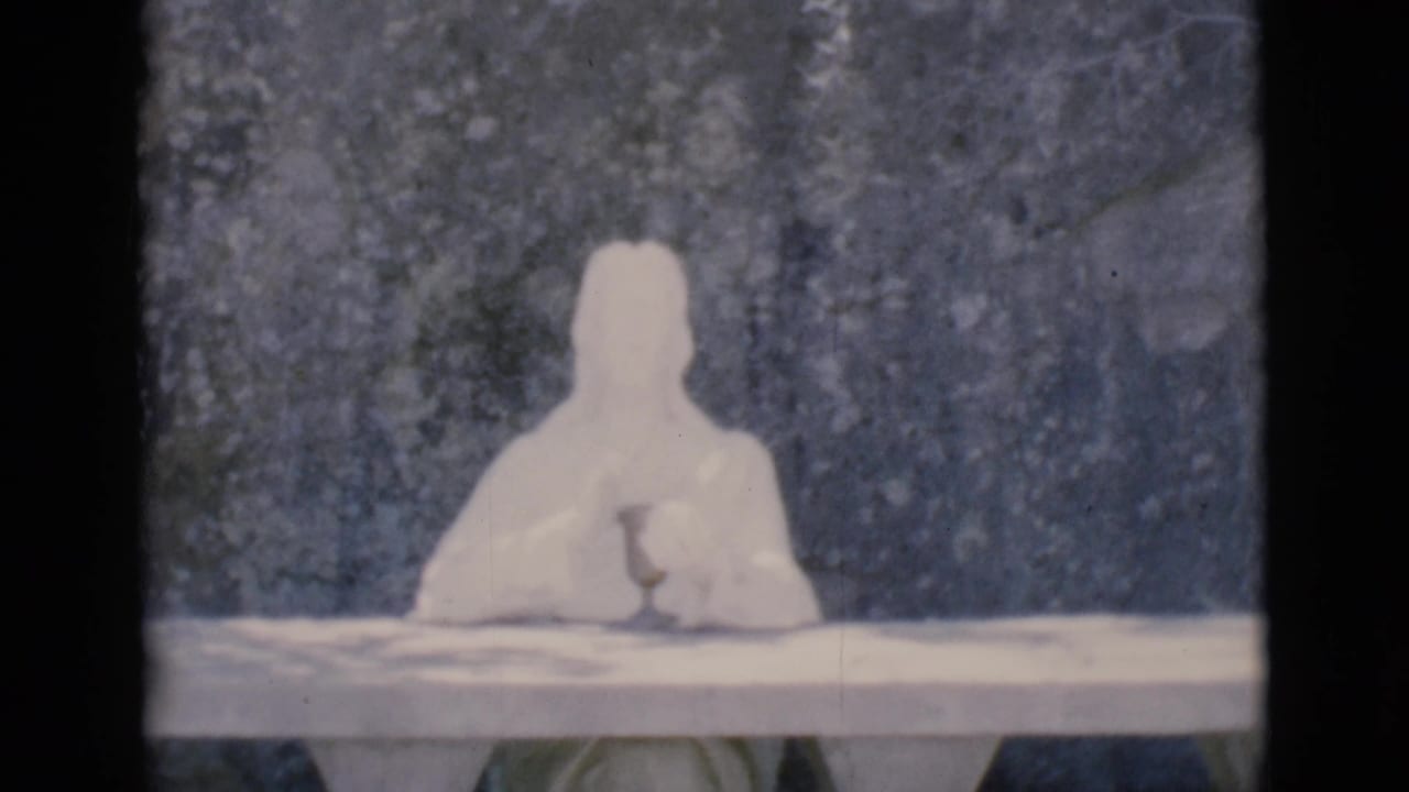 White contemplative statue with a Prayer for Peace plaque below it.