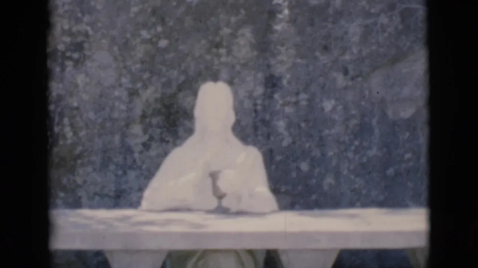 Clarkdale, Arizona 1966 frame with a white devotional statue and partially legible Prayer for Peace plaque beneath.