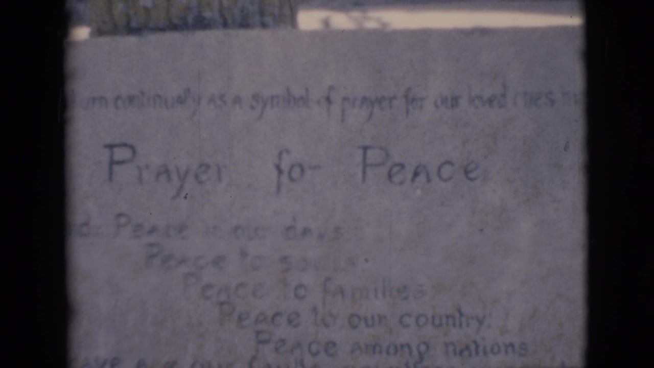 Handwritten Prayer for Peace note on a pale textured surface.