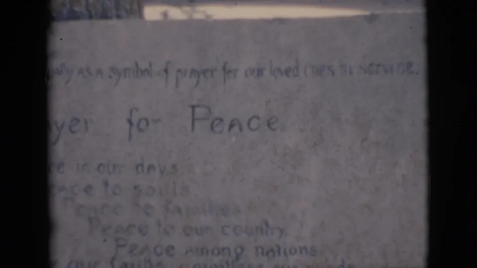 The 8mm frame holds on the handwritten Prayer for Peace text, with several faint peace-related lines below.