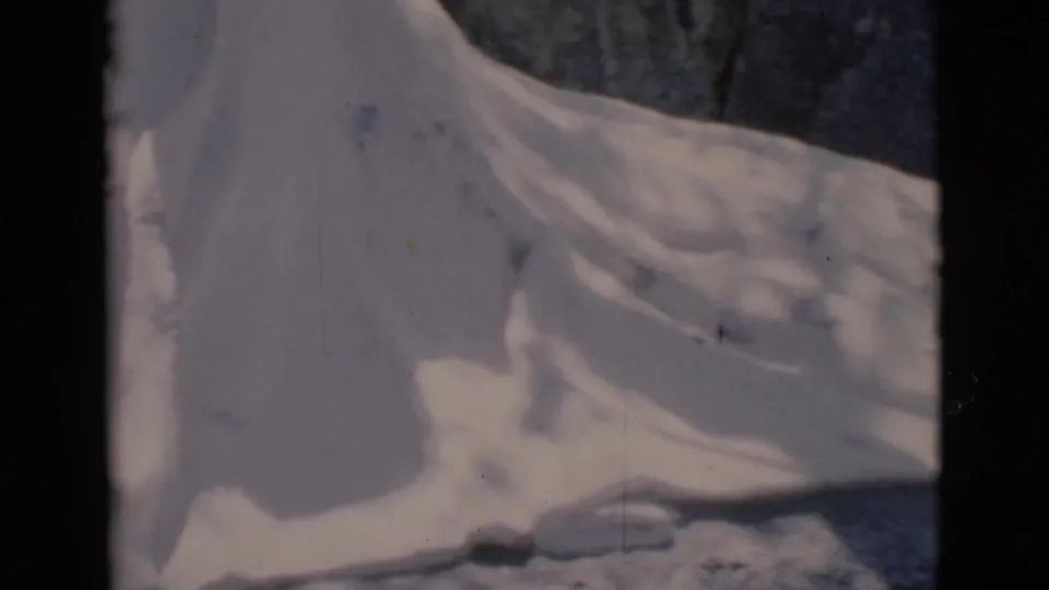 Close 8mm view of a pale gel-like or fabric-like substance on rocks, identified by metadata as Clarkdale, Arizona in 1966.