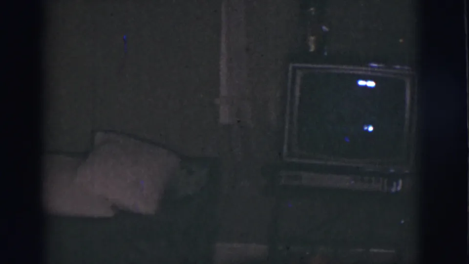 1966 Tucson home interior showing a sofa or cushion at left and a boxy television set against the wall.