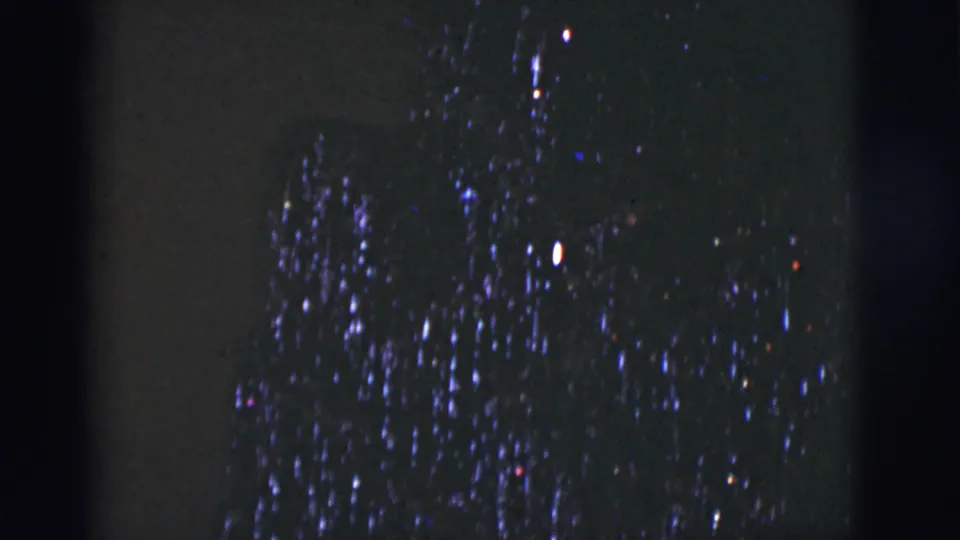 1966 Tucson home-movie frame with dense blue-white lights on a dark tree-like decoration.
