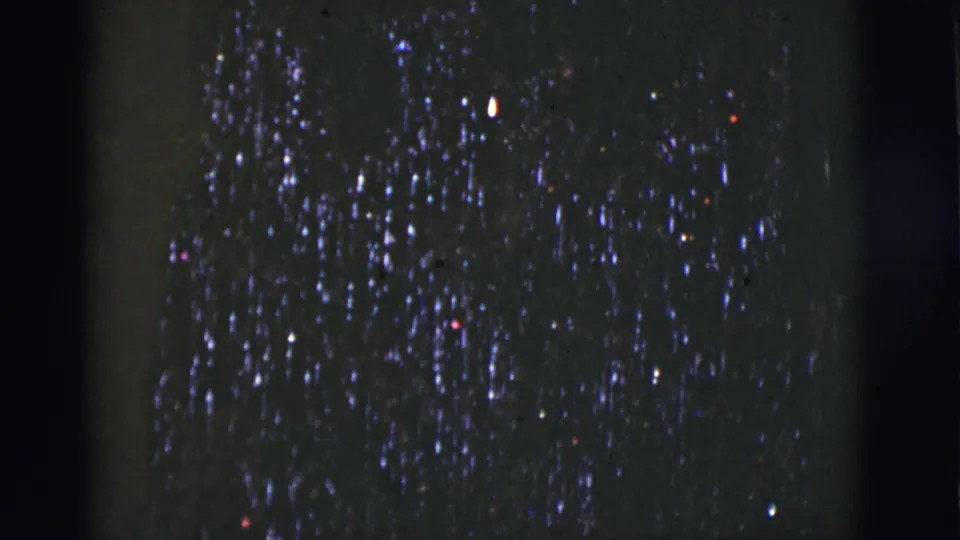 1966 Tucson 8mm frame showing a dark, light-covered tree-like decoration against a nearly black background.