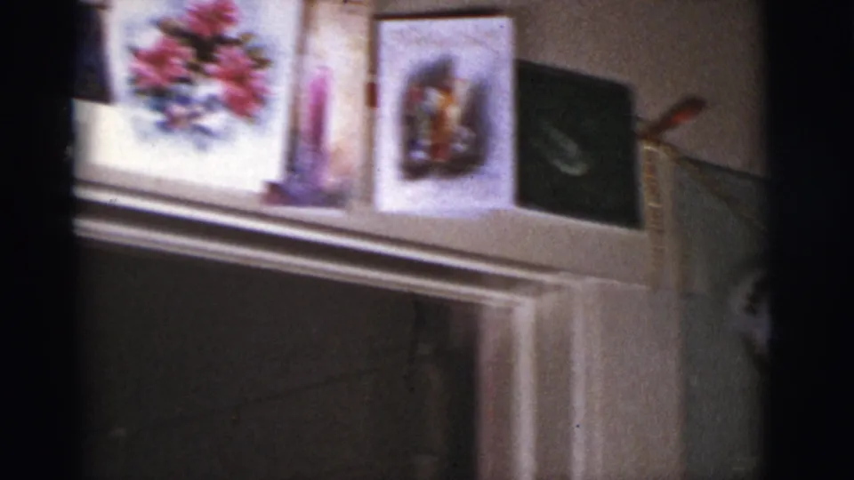 Mantel display in a 1966 Tucson home with holiday cards, a framed picture, and Christmas decorations.