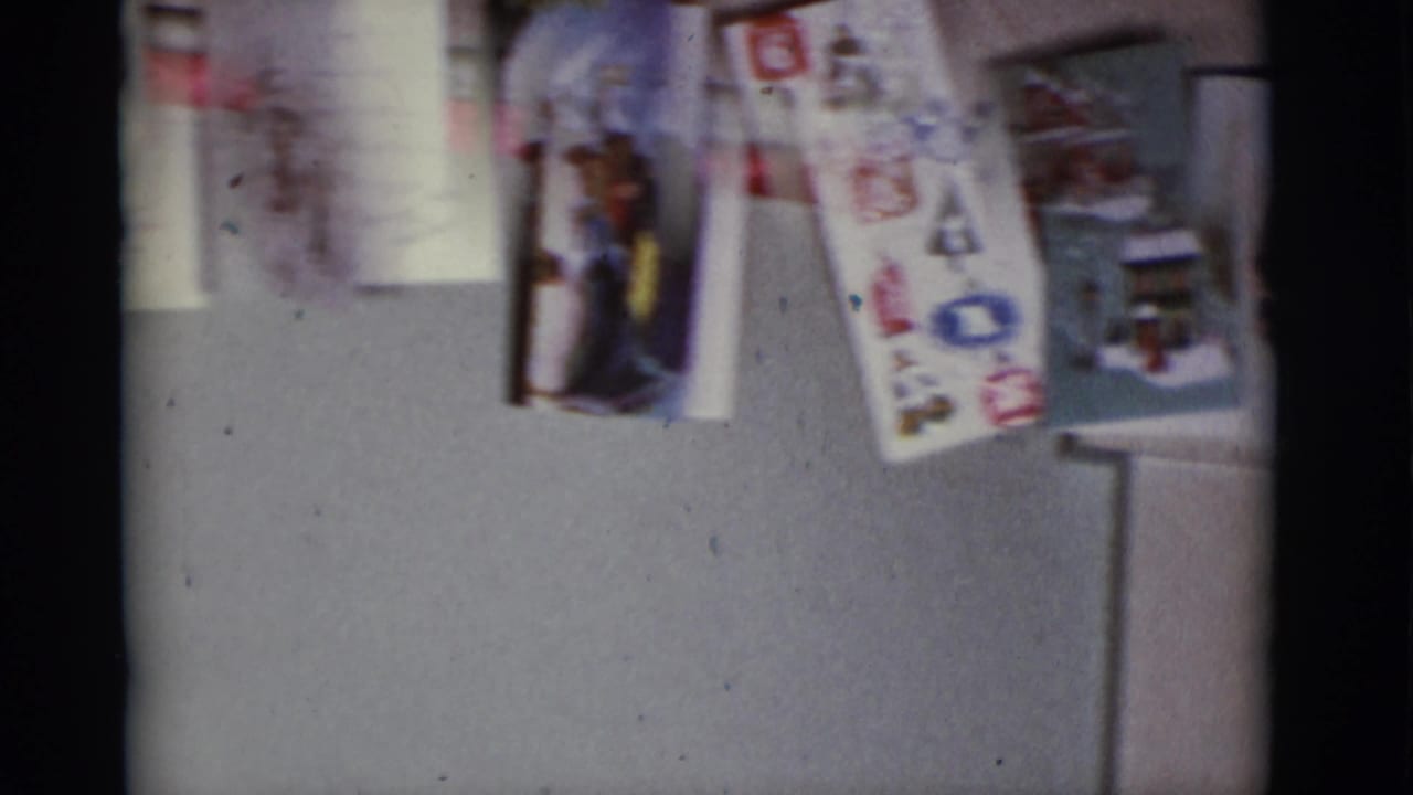 1966 Tuscon home interior with several Christmas cards hanging on a wall, including illustrated seasonal designs.
