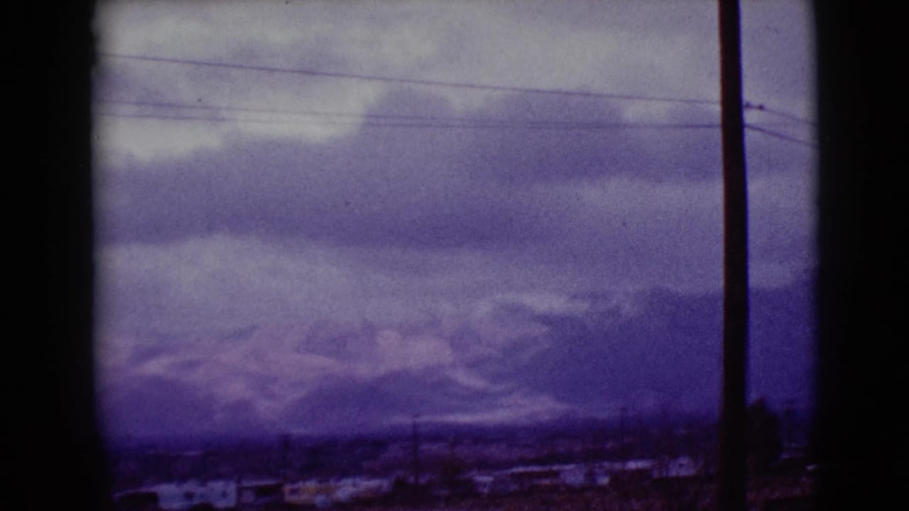 1968 Clarksdale, Arizona view of mist-softened mountains, low clouds, overhead wires, and a foreground utility pole.