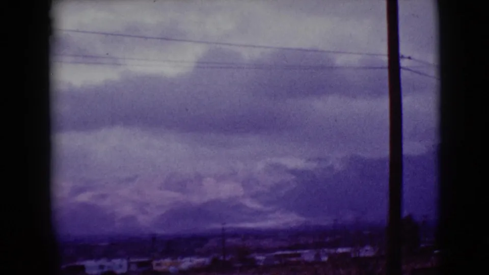 1968 Clarksdale, Arizona view of mist-softened mountains, low clouds, overhead wires, and a foreground utility pole.
