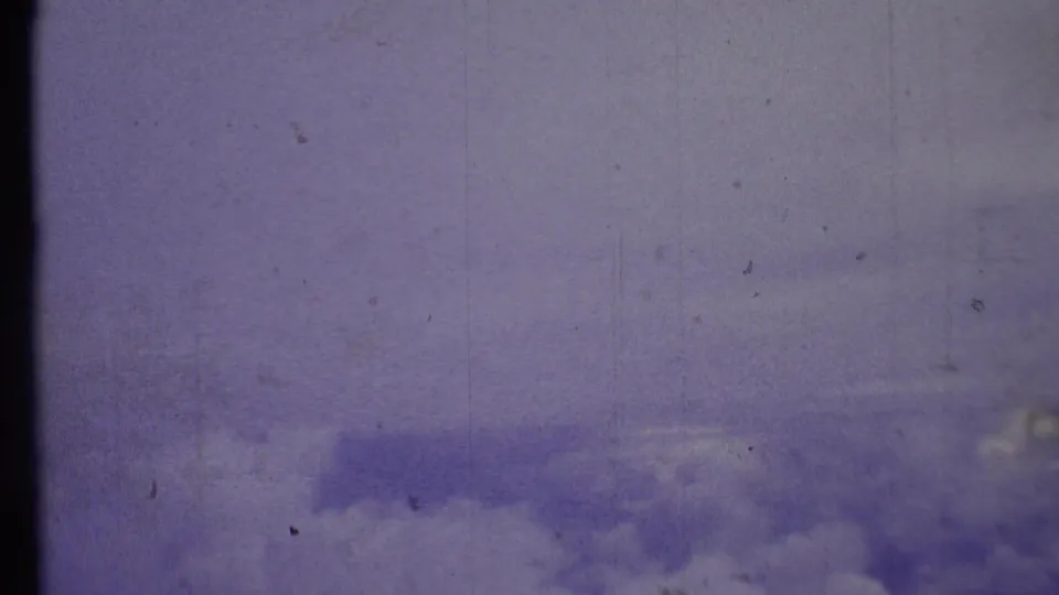 1972 8mm Grand Canyon-area home-movie frame showing a lavender-blue sky with soft clouds and film wear.
