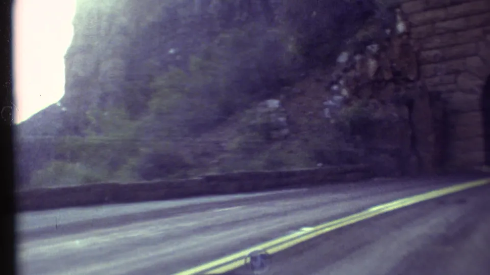 1972 Grand Canyon road footage showing the vehicle drawing close to a brick-lined tunnel entrance.