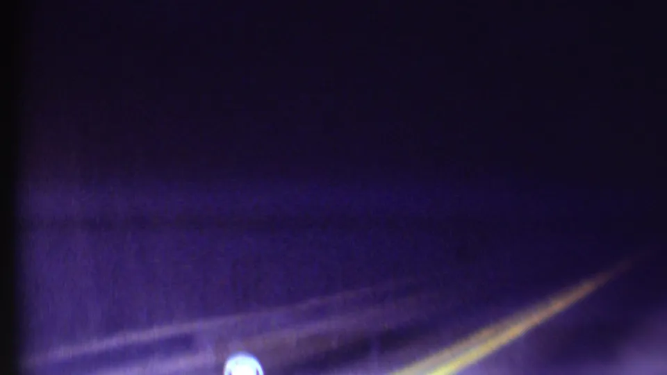 1972 Grand Canyon 8mm frame inside the dark tunnel, showing road markings under strong purple-blue aging.