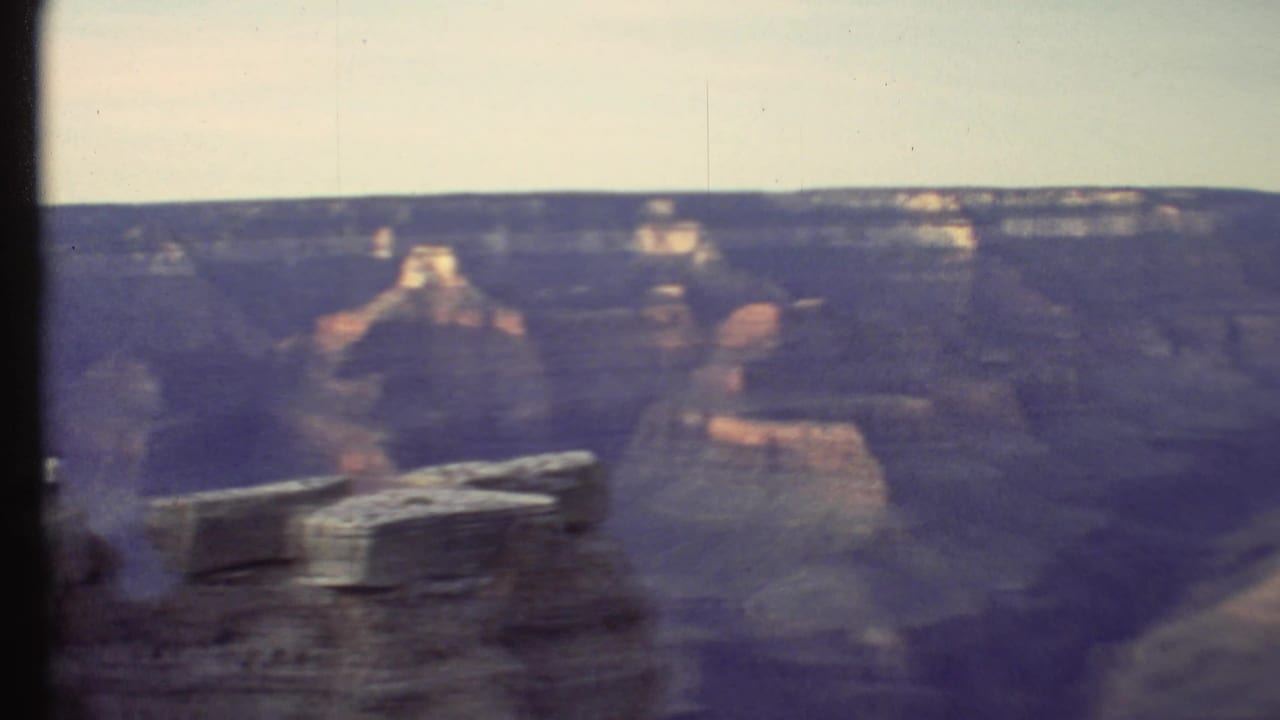 Handheld 1972 8mm pan across the Grand Canyon, with muted purple shadows and pale sky.
