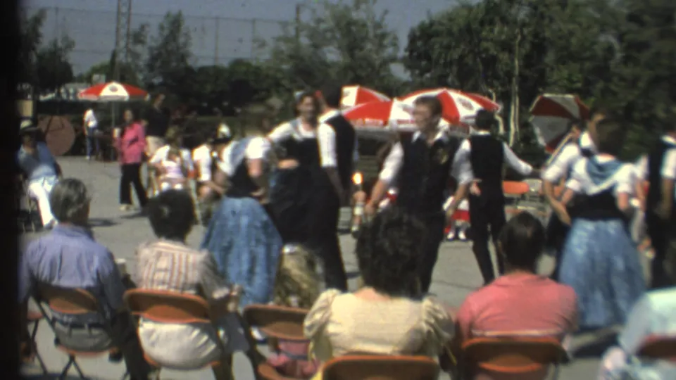 1972 Grand Canyon home-movie frame with folk dancers in vests and skirts performing before a seated audience.