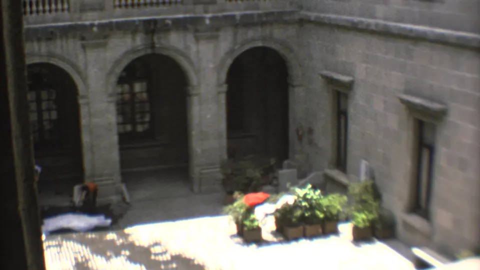 1973 Mexico City 8mm view of a church or historic building courtyard with stone arches, potted plants, and bright sunlight.