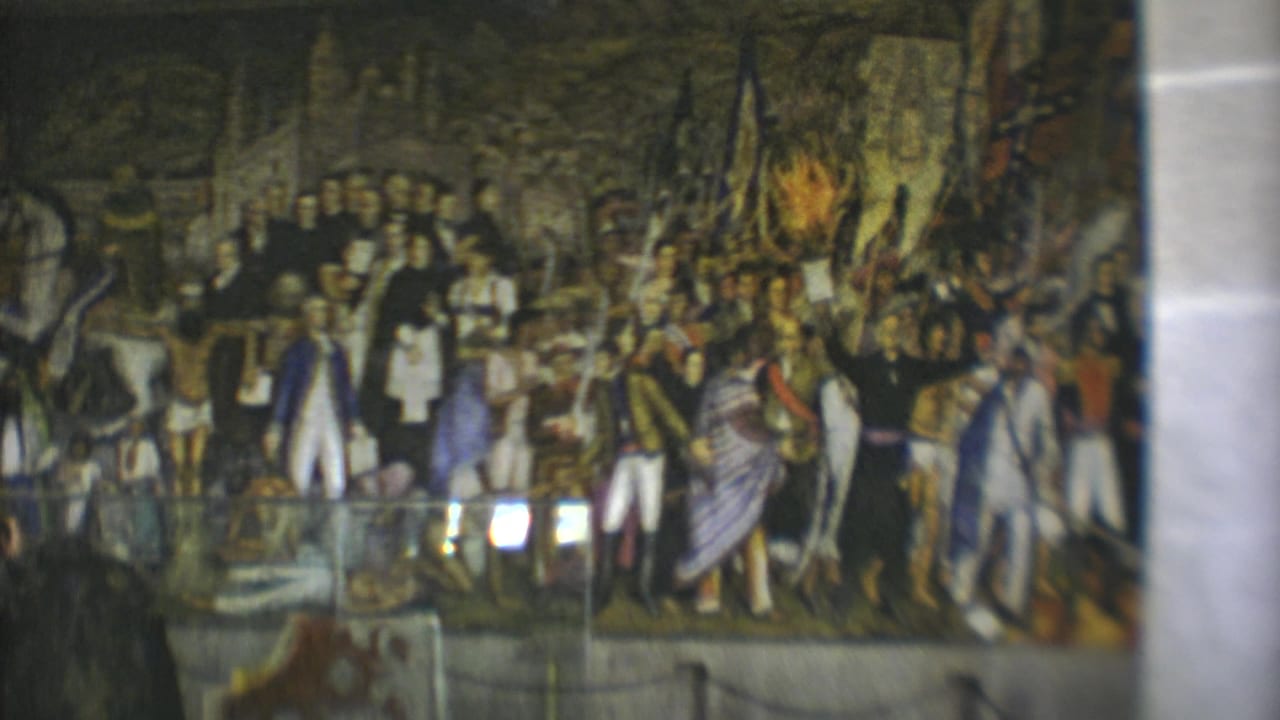 1973 Mexico City museum visitors view a large historical mural framed by columns and glass reflections.