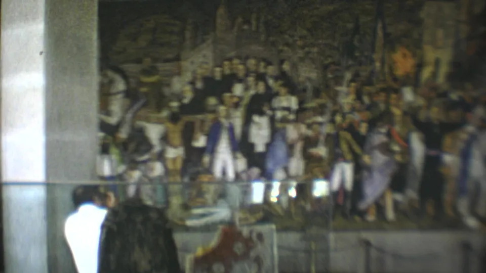 A 1973 museum view shows a visitor near reflective glass with a detailed historical mural behind it.