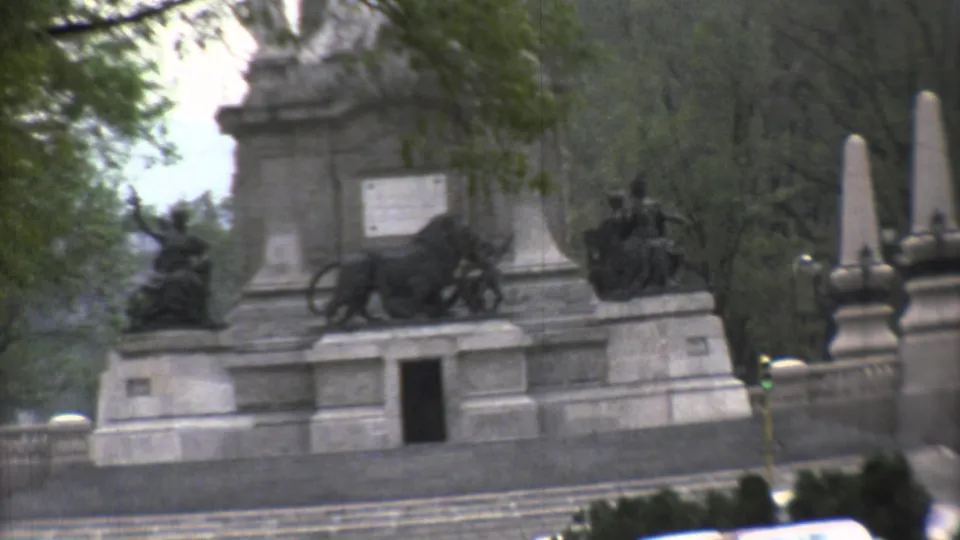 A closer 1973 Mexico City view shows a stone monument with lion sculptures, steps, trees, and roadside foreground.