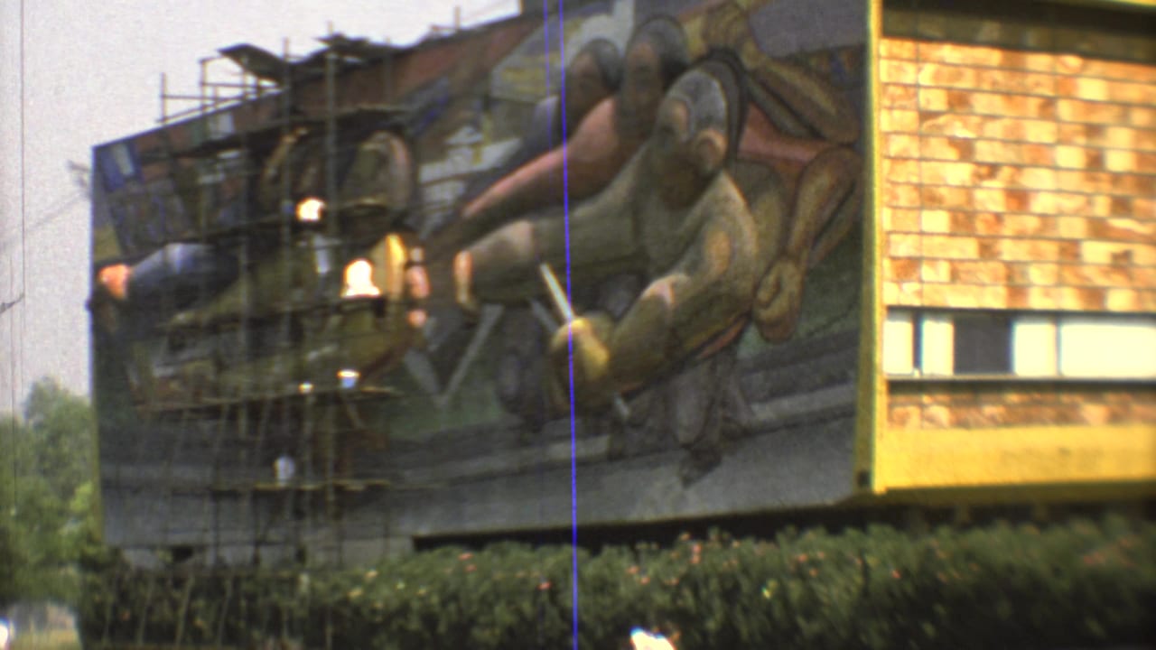 Closer 1973 Mexico City frame of a building mural with scaffolding and lamps in front of stylized painted figures.