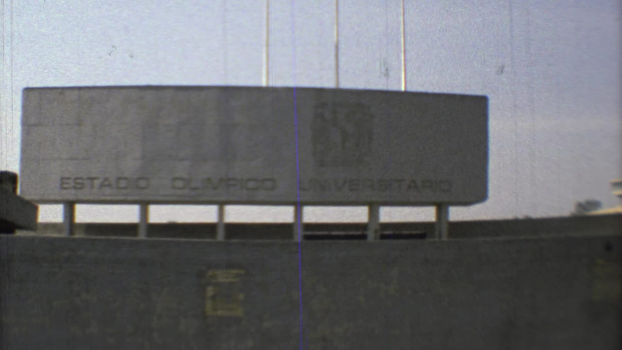 1973 Mexico City 8mm view of the Estadio Olimpico Universitario sign, concrete wall, and shaded lower opening.