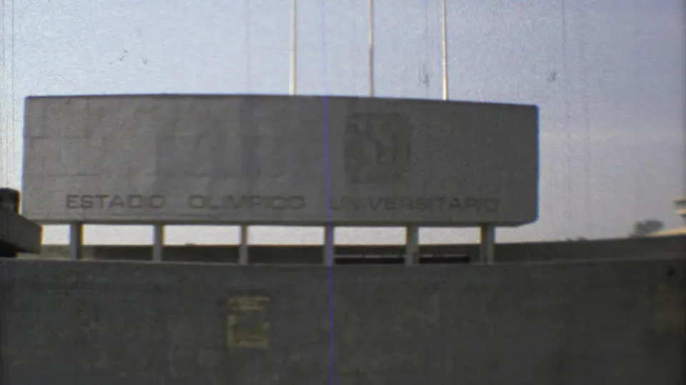 1973 Mexico City 8mm view of the Estadio Olimpico Universitario sign, concrete wall, and shaded lower opening.