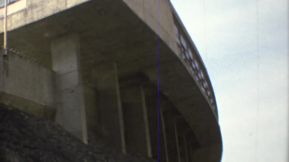 1973 Mexico City frame showing the underside of Estadio Olimpico Universitario's curved concrete stand with vertical supports.
