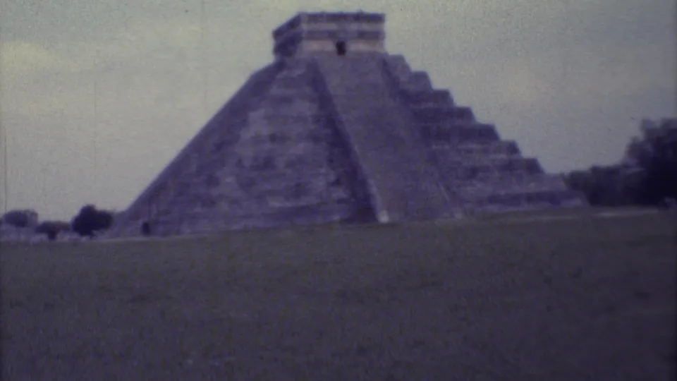 A closer 1973 8mm view of the Chichen Itza pyramid shows its stepped sides, central stair area, and open grounds.