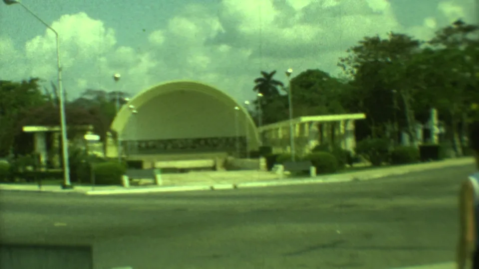 1973 Yucatan street scene with the yellow domed building in the background and a woman partly visible at the lower right edge.