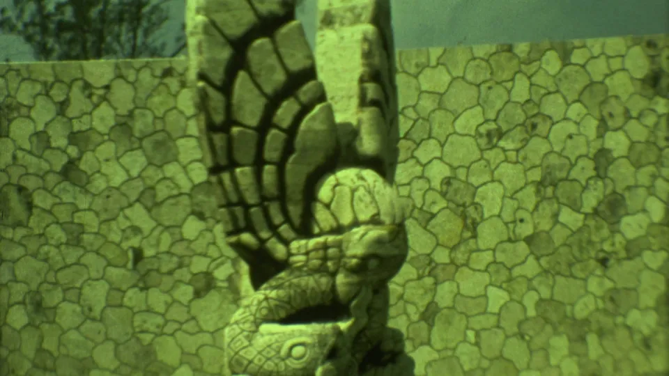 1973 Yucatan frame showing a close sculptural stone detail, wall patterning, and green-tinted 8mm texture.