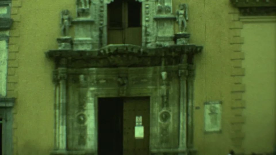 1973 Yucatan 8mm frame showing an ornate colonial-style stone entrance with carved figures and an open doorway.