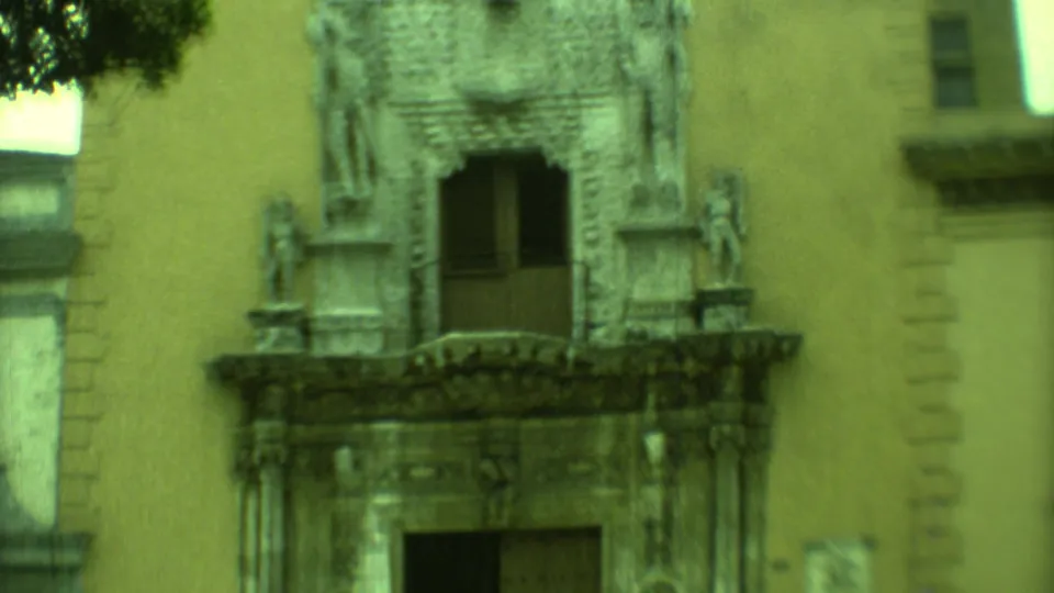 1973 Yucatan home-movie frame showing another ornate colonial-style entrance with sculptural stonework on a stucco facade.