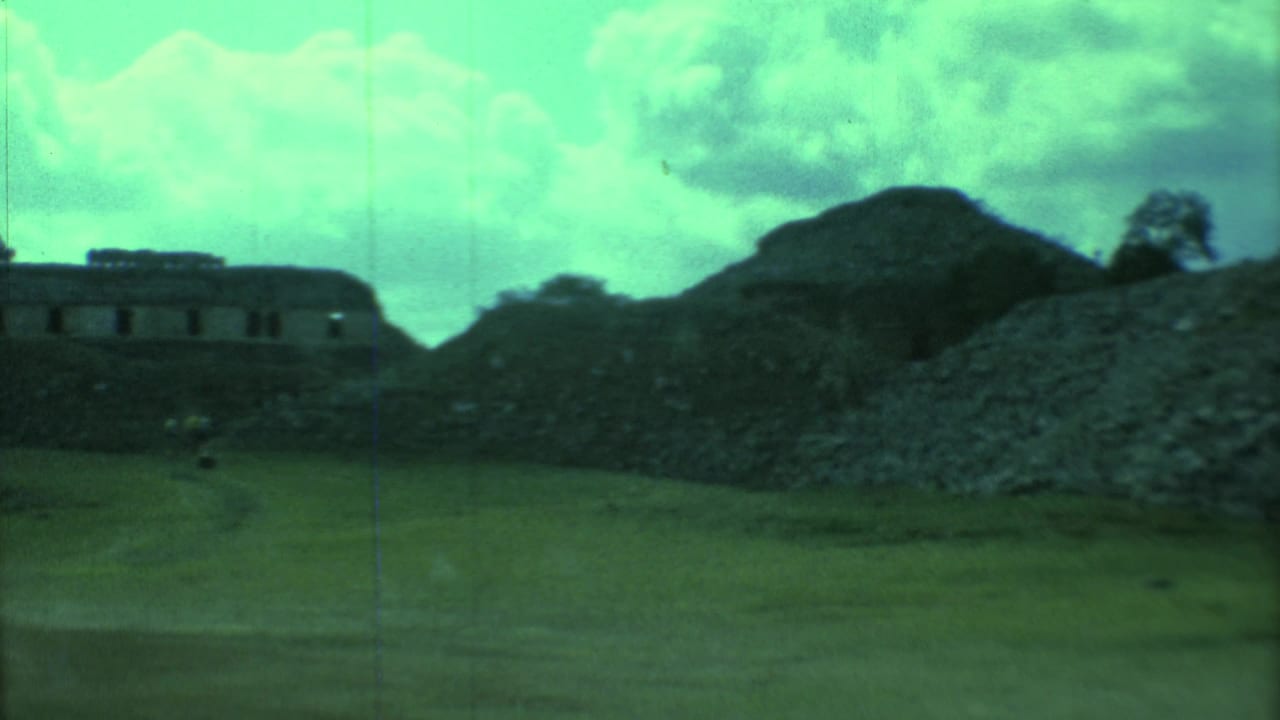 Green-tinted view of stone ruins, grassy ground, and cloudy sky.