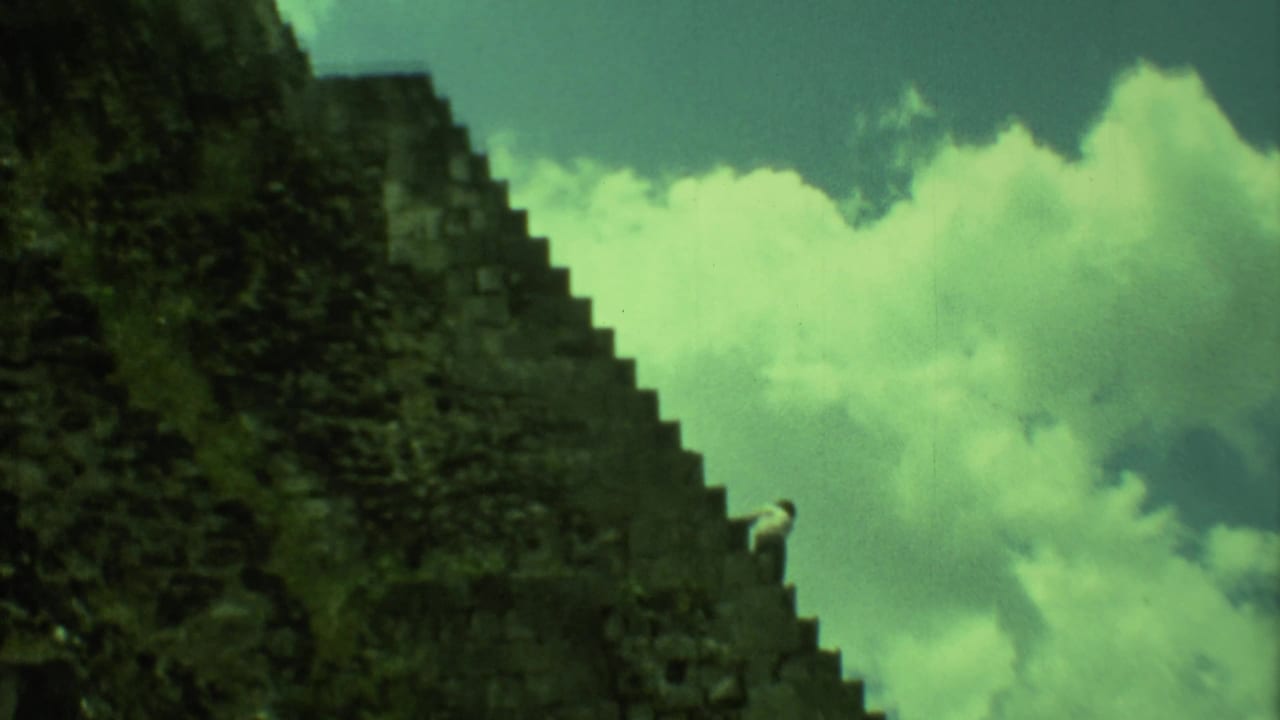 Steep pyramid stairs with a small distant figure near the upper steps.