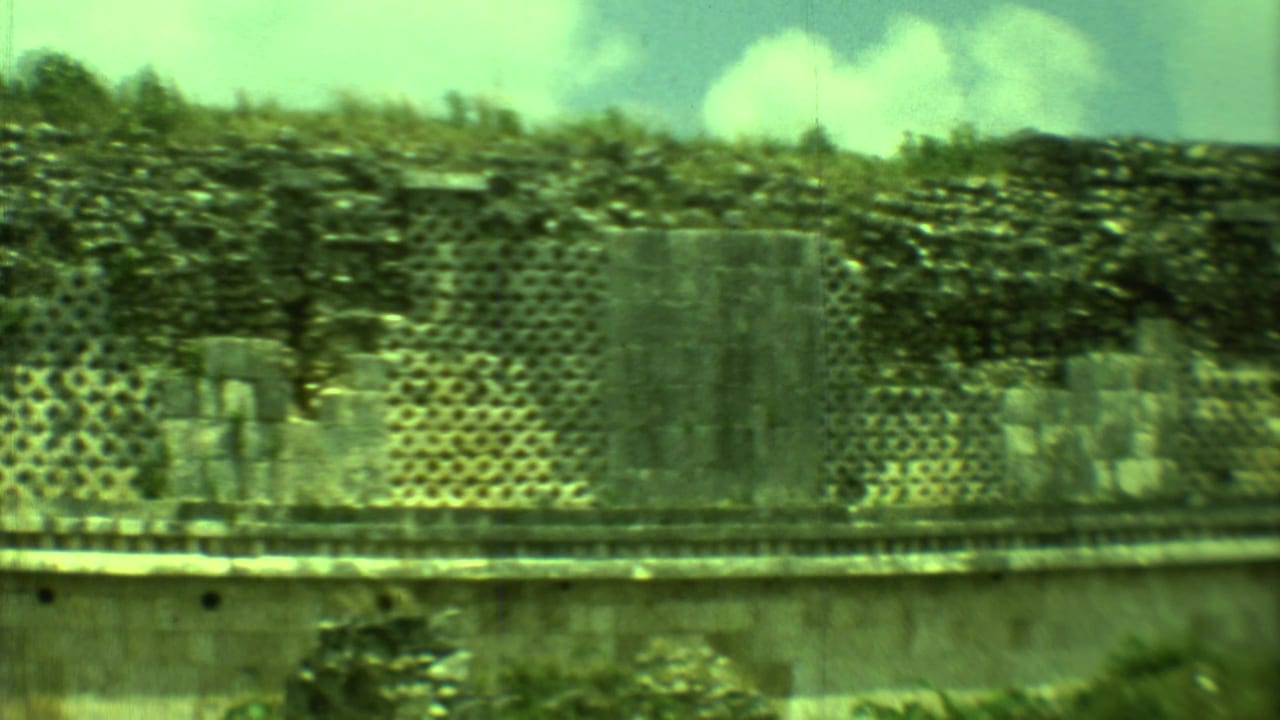 Ruined stone structure with patterned masonry and taller broken wall sections.