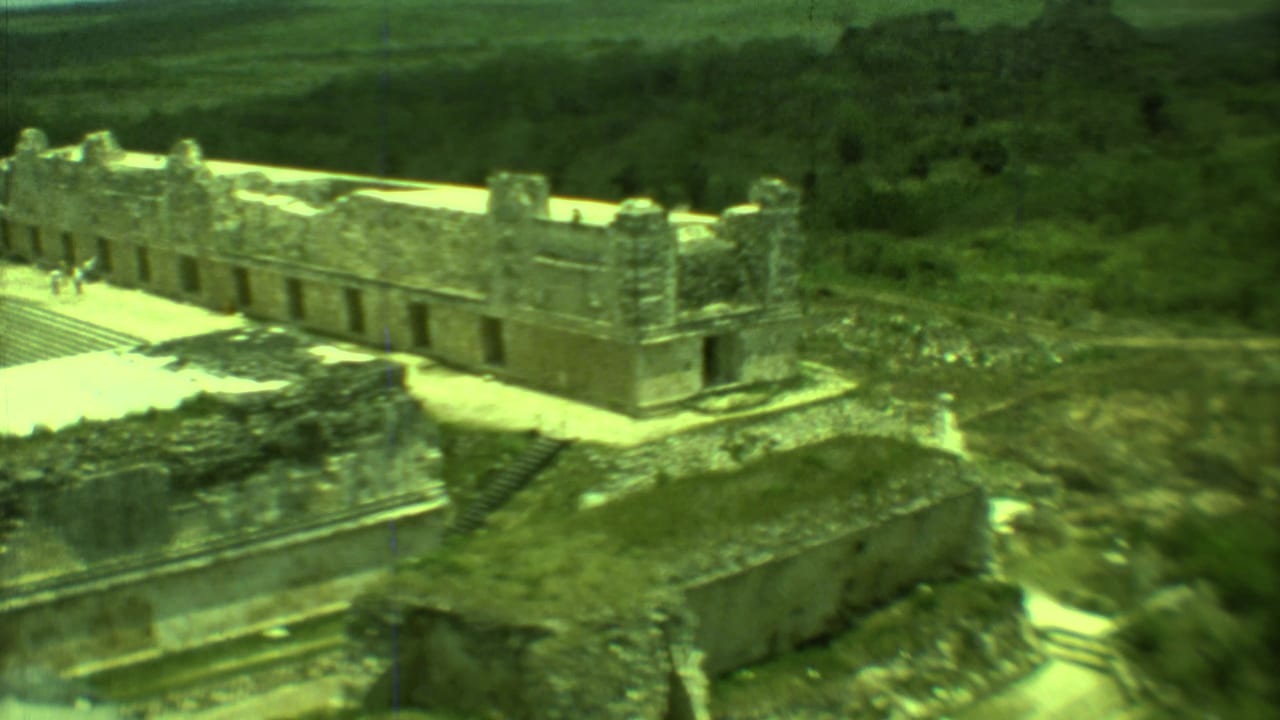 Stone ruin complex with a few small visitors on the bright walkway.