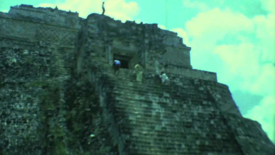 1973 Yucatan 8mm view of visitors on a steep stone stairway leading to an ancient temple entrance.