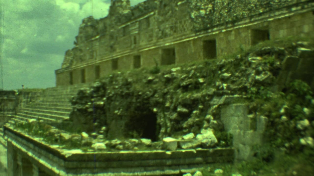 Ruined stone building with steps, rubble, vegetation, and open doorways.